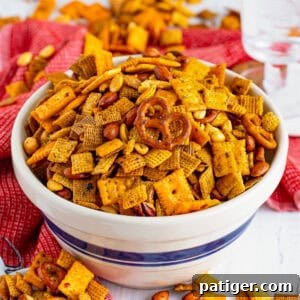 Firecracker spicy chex mix with pretzels, crackers, nuts, coated in a spicy ranch seasoning mix.