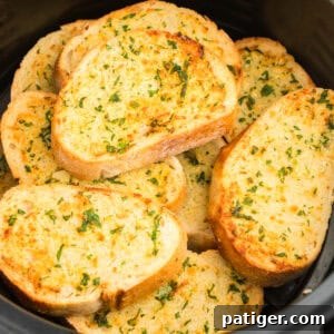 Golden Garlic Bread in Minutes 11 Slices of thick garlic bread stacked in air fryer basket.