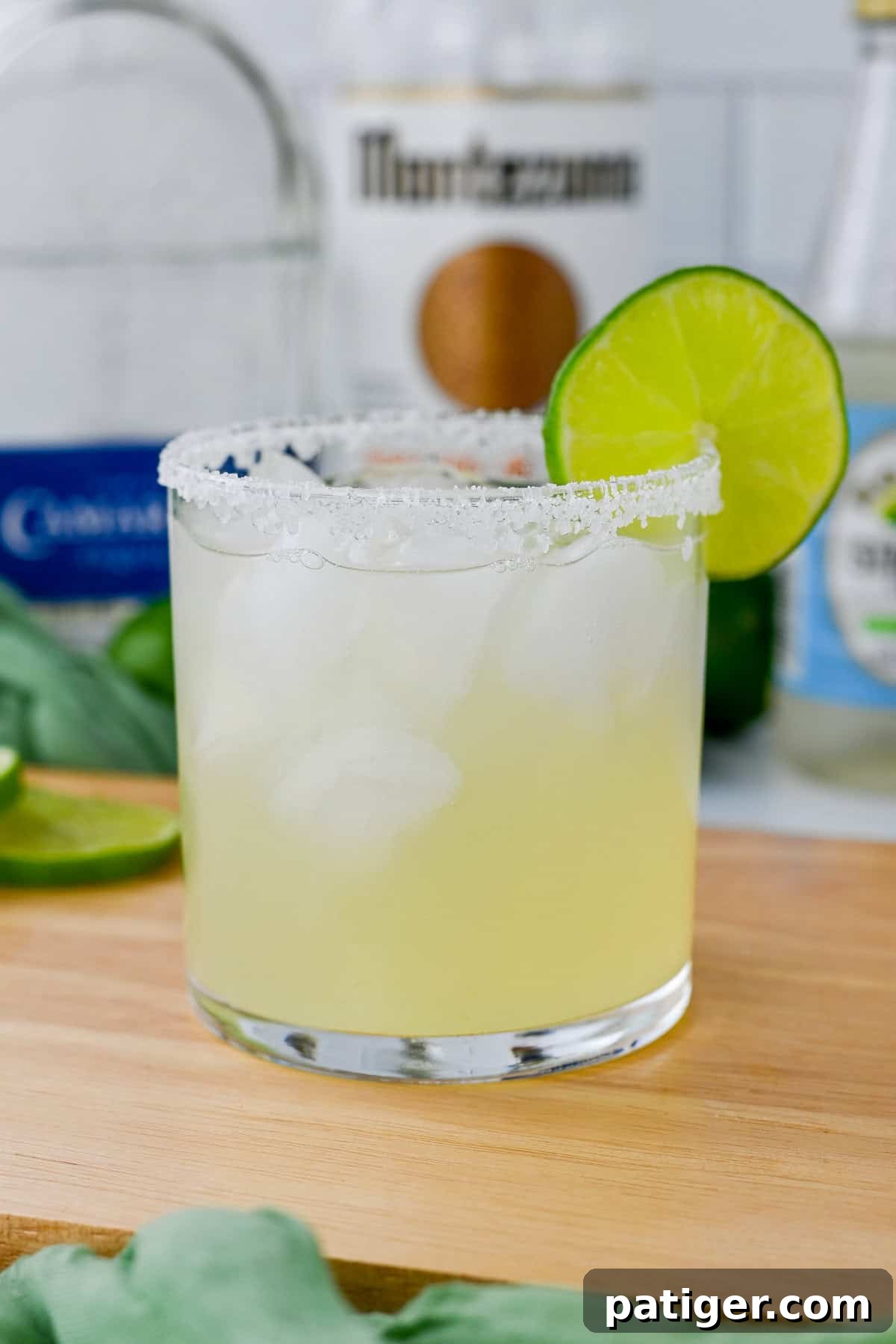 Classic Margarita on the rocks with a perfectly salted rim and a vibrant lime garnish, ready to be enjoyed.