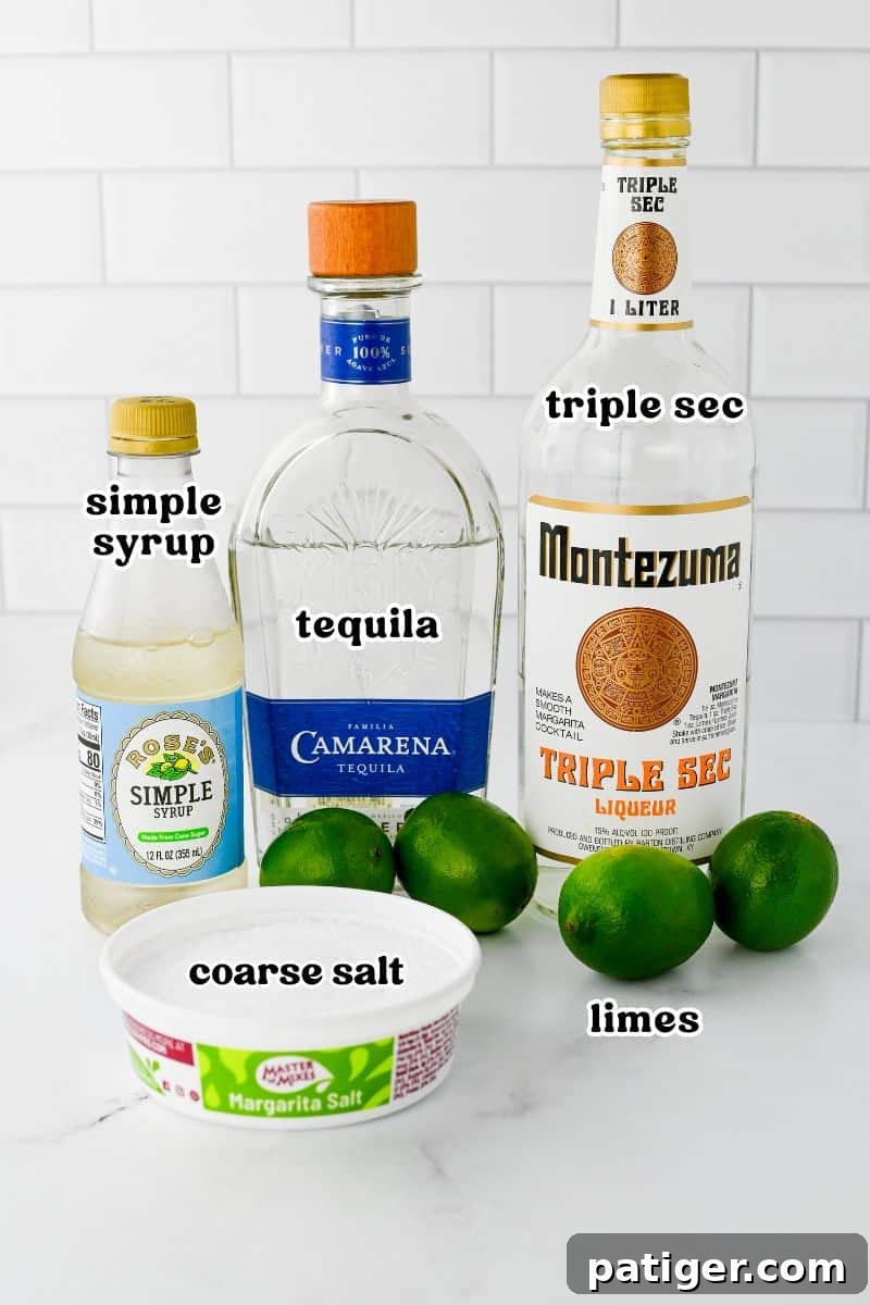 The essential ingredients for a classic margarita: tequila, triple sec, simple syrup, coarse salt, and fresh limes.