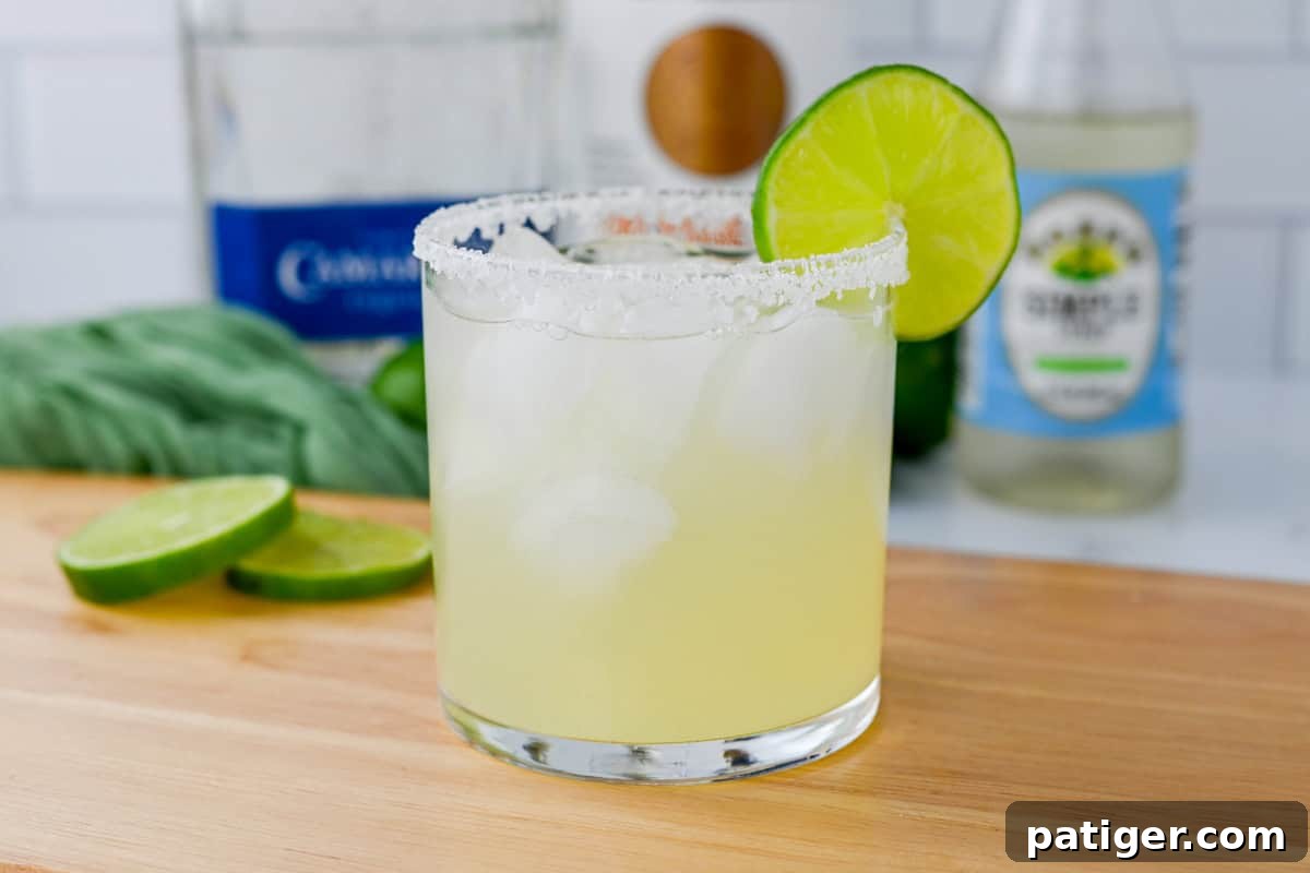 An easy traditional margarita recipe, served on the rocks with a crisp salted rim and a refreshing lime garnish.