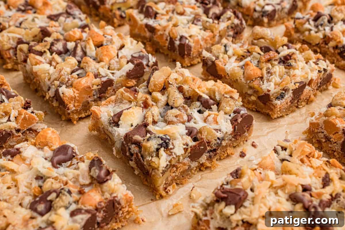 7 layer magic cookie bar squares on parchment paper.