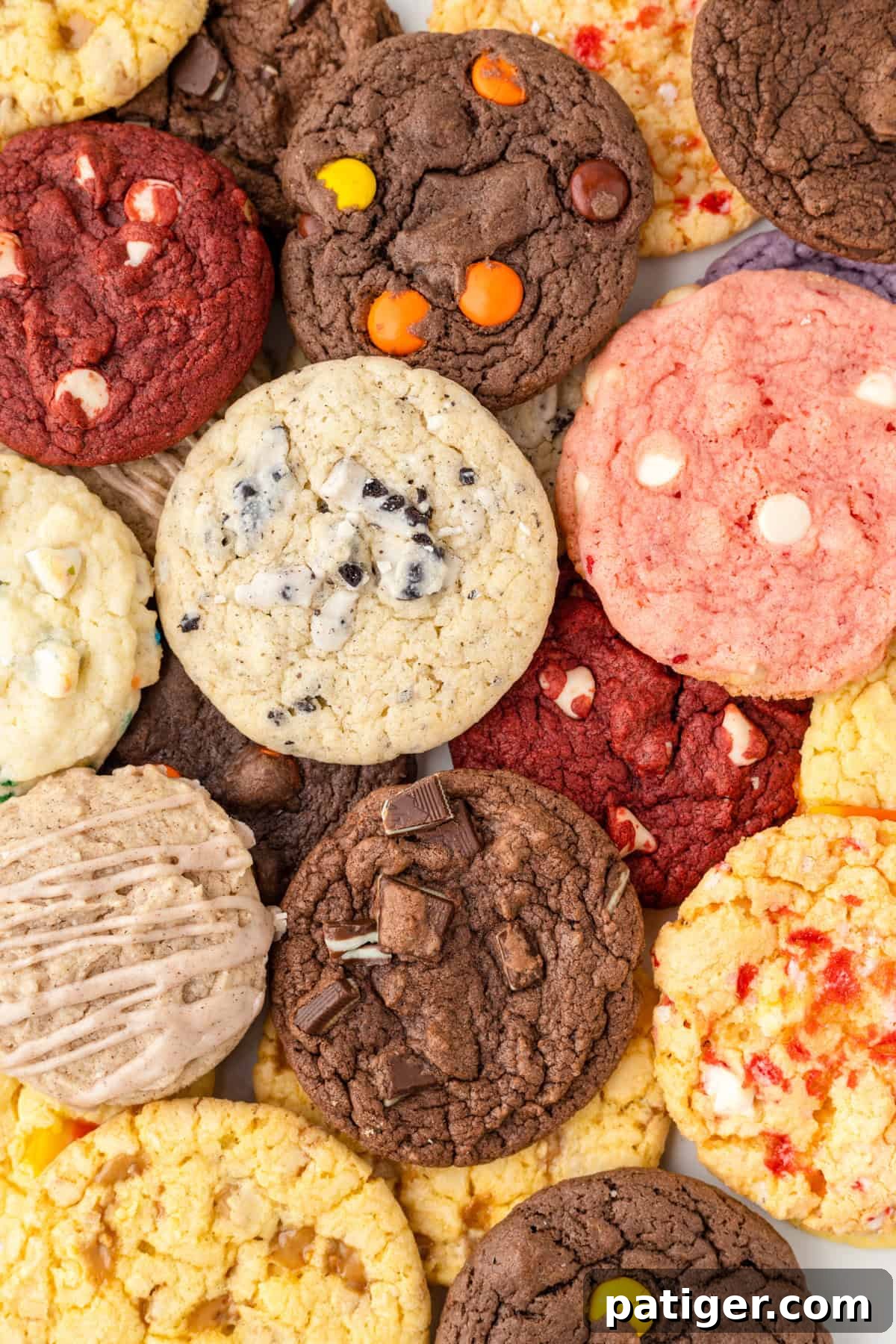 A vibrant assortment of cake mix cookies, showcasing a variety of flavors like strawberry with white chocolate chips, cookies and cream, toffee, Reese's peanut butter, chocolate, and lemon cake mix cookies, all freshly baked and ready to enjoy.