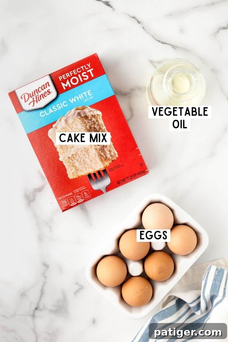 The three essential ingredients for easy cake mix cookies: a colorful box of cake mix, a bottle of vegetable oil, and fresh eggs, arranged simply on a countertop.