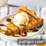 Slow Cooker Chocolate Chip Cookie served with vanilla ice cream and sauces.