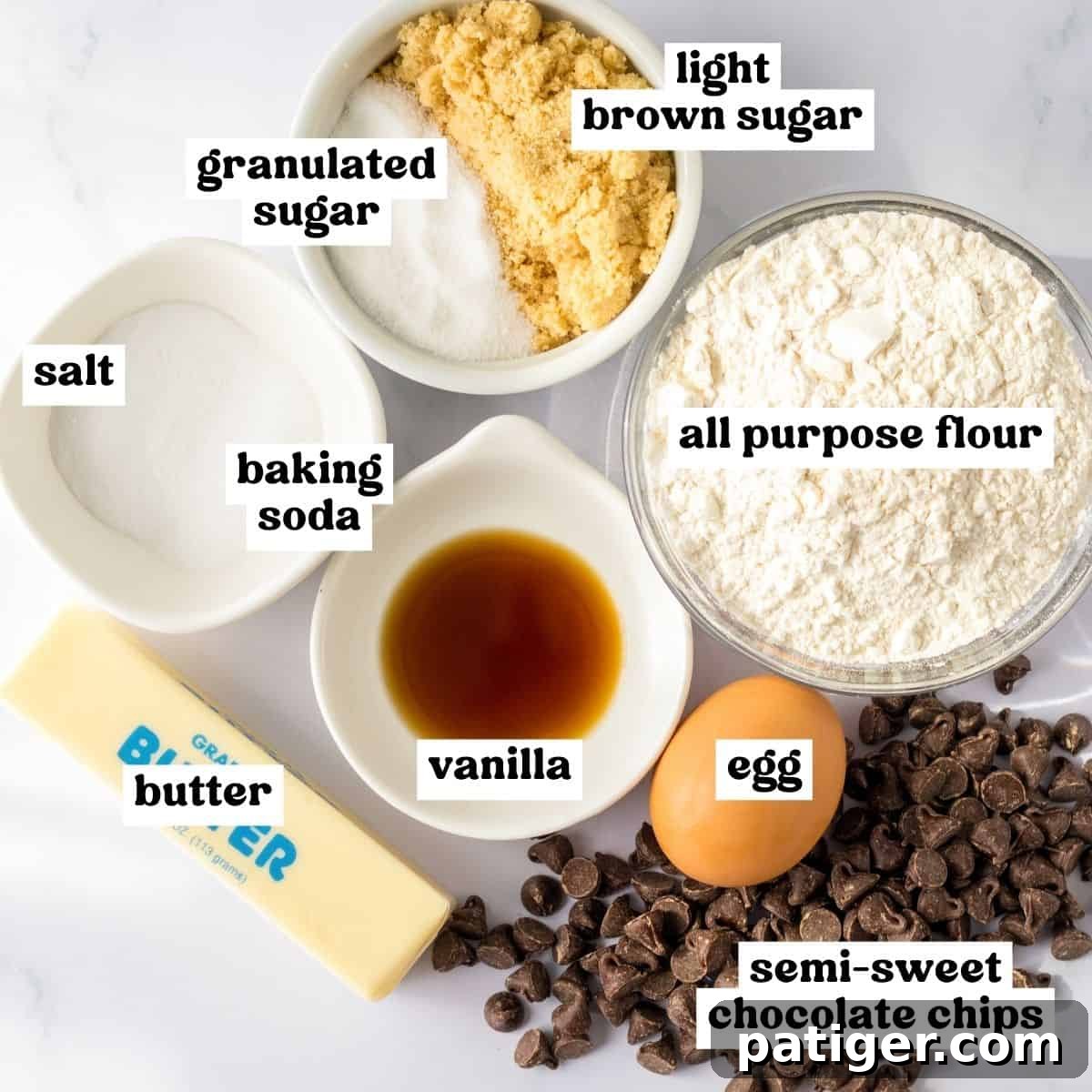 Ultimate Slow Cooker Chocolate Chip Cookie 3 All the necessary ingredients for a delicious crockpot chocolate chip cookie are neatly laid out on a clean surface: softened butter, granulated sugar, light brown sugar, a large egg, vanilla extract, all-purpose flour, baking soda, salt, and semi-sweet chocolate chips.