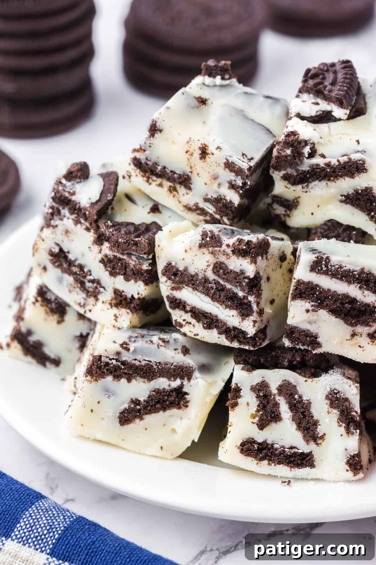 Super Simple 3-Ingredient Oreo Fudge 3 White chocolate Oreo cookie fudge piled on a plate.