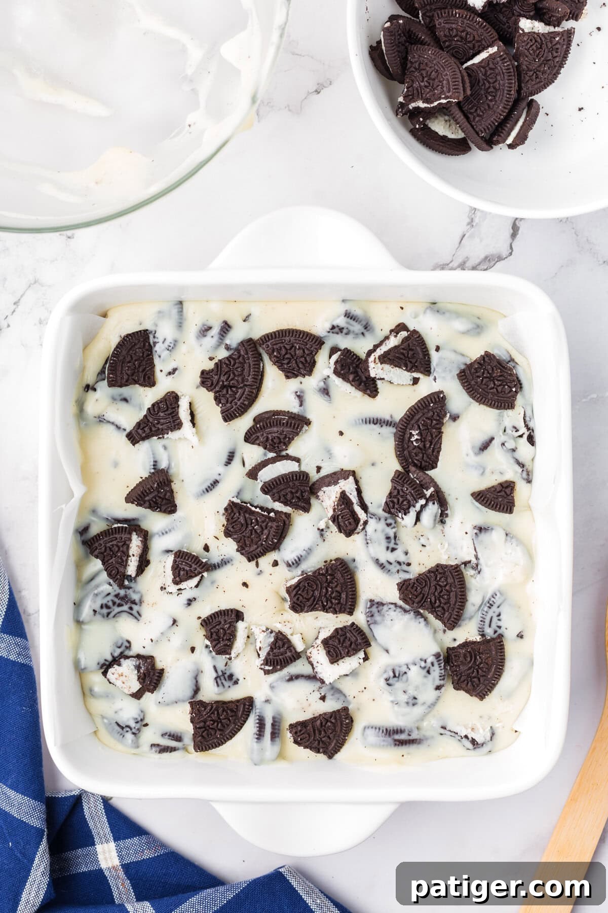 Super Simple 3-Ingredient Oreo Fudge 7 Oreo cookie fudge in square baking dish lined with parchment paper.
