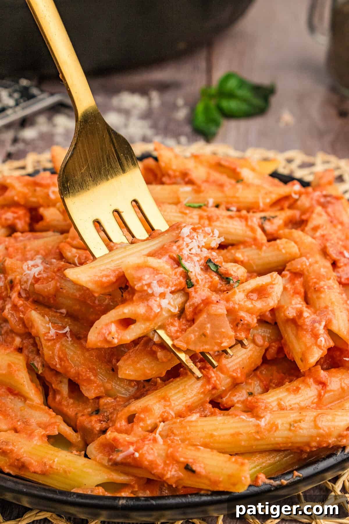 A forkful of Penne alla Vodka showcasing the creamy sauce and pasta texture.