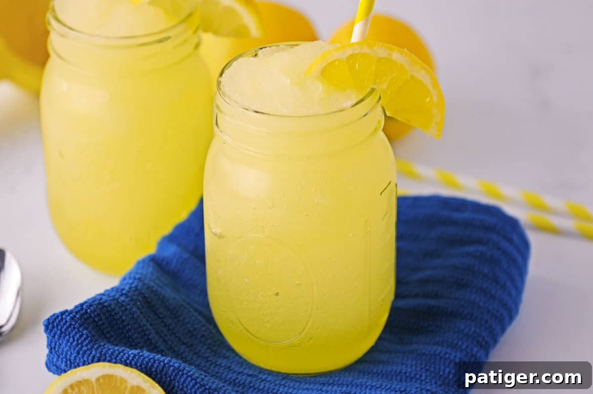 Lemonade slushy made with fresh lemon and served in a mason jar.
