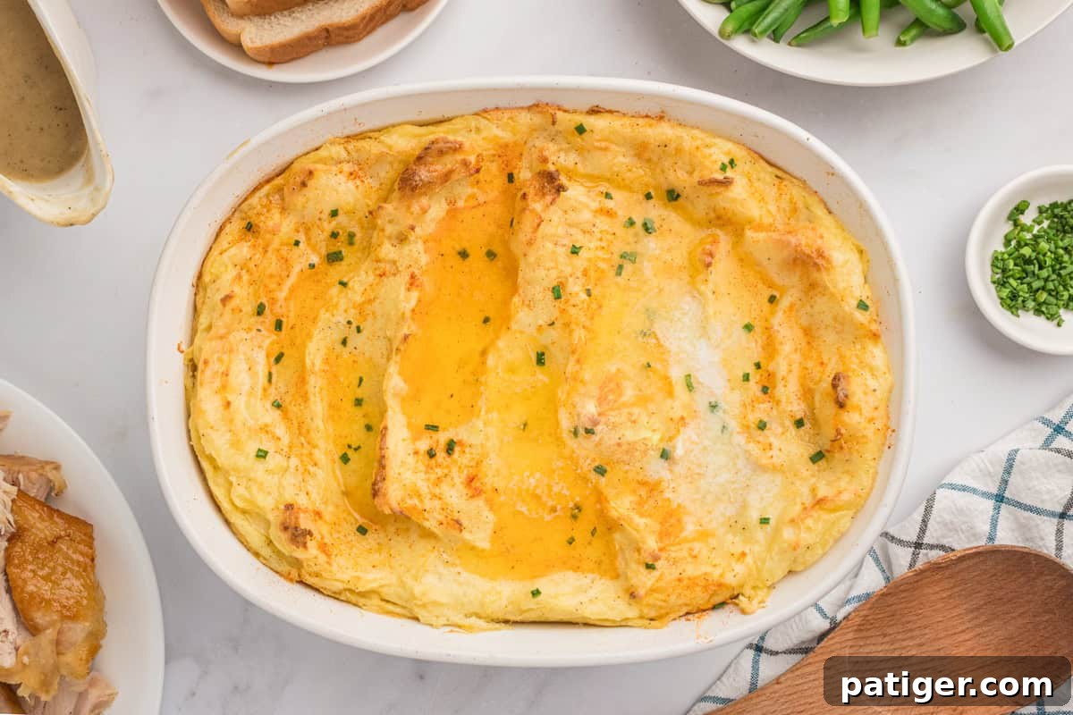 Spud-tacular Party Bites 12 Party Mashed Potatoes with Cream Cheese in baking dish on holiday dinner table.