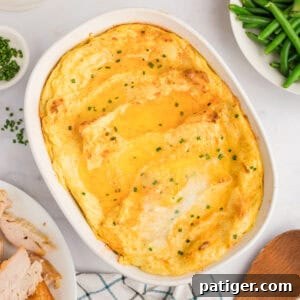 Party Potatoes with cream cheese surrounded by holiday meal including turkey, gravy, and green beans.