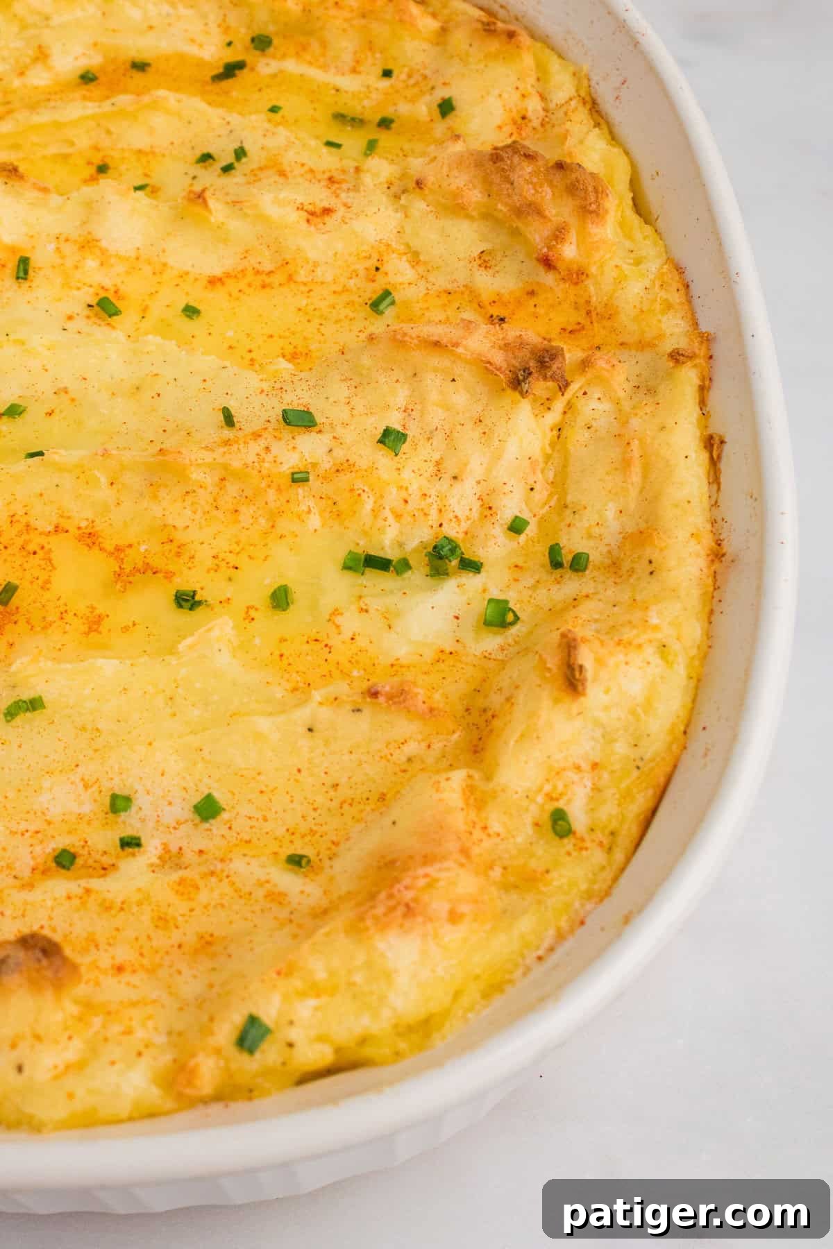 Spud-tacular Party Bites 8 Party mashed potatoes with cream cheese baked in a white casserole dish until top is golden.