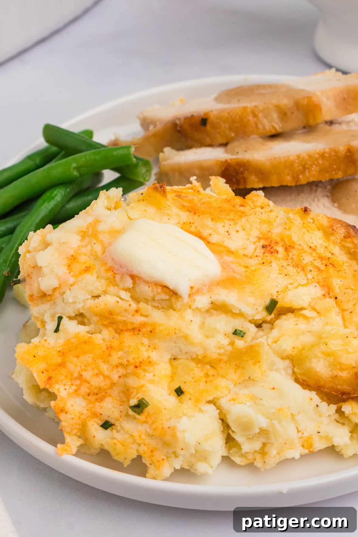 Spud-tacular Party Bites 9 Party mashed potatoes on plate with green beans and sliecd turkey.