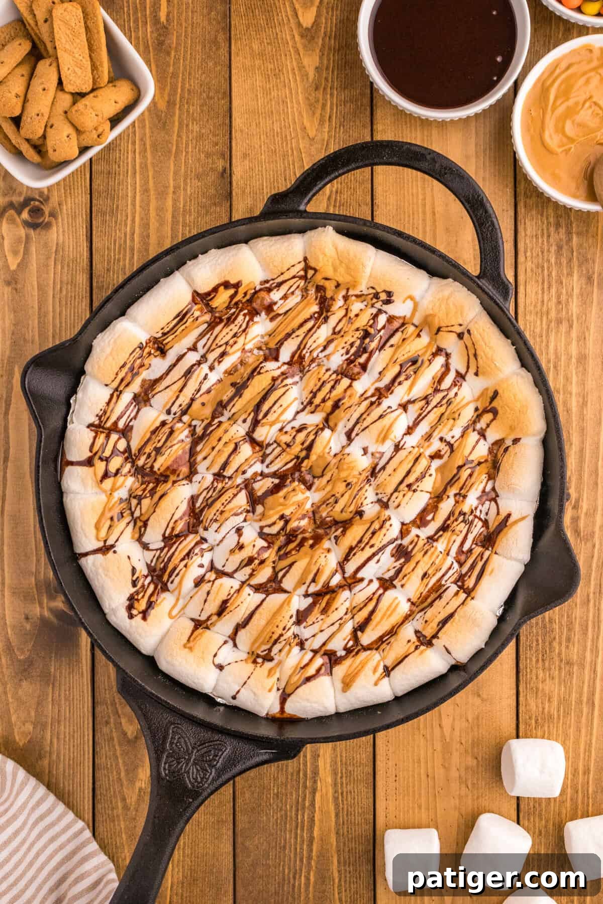 Peanut Butter Cup S'mores Dip in a cast iron skillet with graham crackers for dipping.