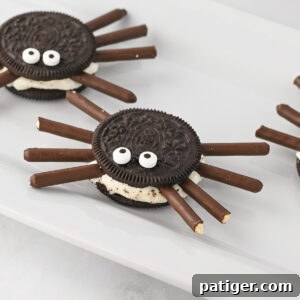 Oreo spiders made with mega stuff oreo cookies, chocolate pocky sticks, and candy eyes.