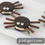 Oreo spiders made with mega stuff oreo cookies, chocolate pocky sticks, and candy eyes.