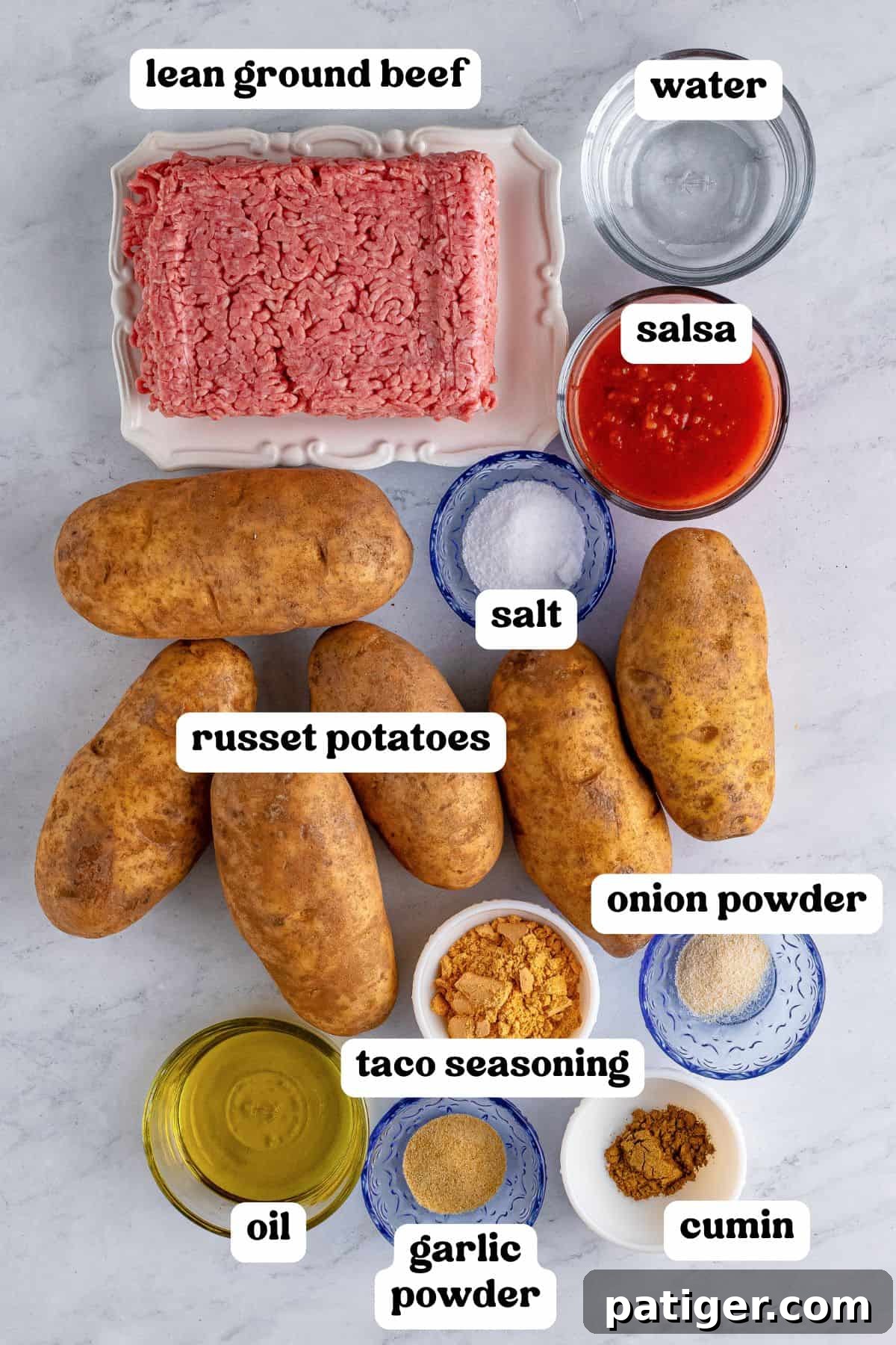 Taco Spud Boats 3 The ingredients for taco stuffed potatoes laid out on a countertop, including russet potatoes, ground beef, olive oil, salsa, and seasonings.