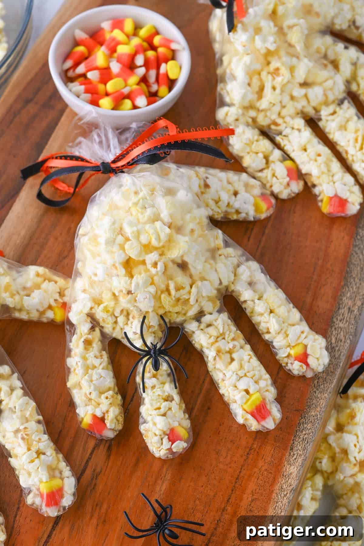 Spooky Popcorn Paws 2 Halloween Popcorn Hands made with disposable gloves stuffed with candy corn at the finger tips and popcorn.