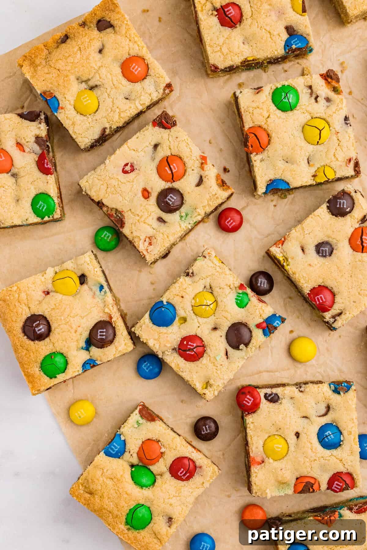 Sliced bar cookies with M&Ms and chocolate chips, showcasing their soft, chewy texture and colorful appeal.