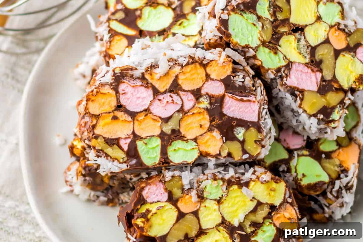 Stained Glass Cookies 8 Close-up of no-bake church window cookies featuring colorful pastel marshmallows, chopped walnuts, chocolate, and a shredded coconut topping.