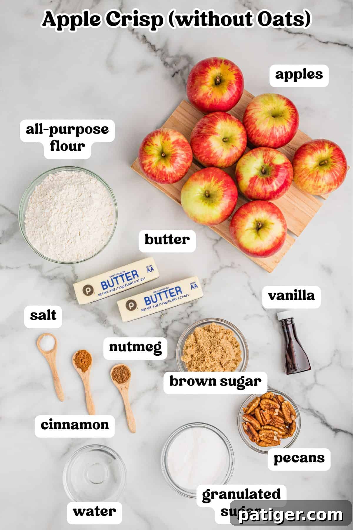All ingredients for apple crisp without oats laid out and labeled, including apples, butter, flour, sugars, cinnamon, and pecans.
