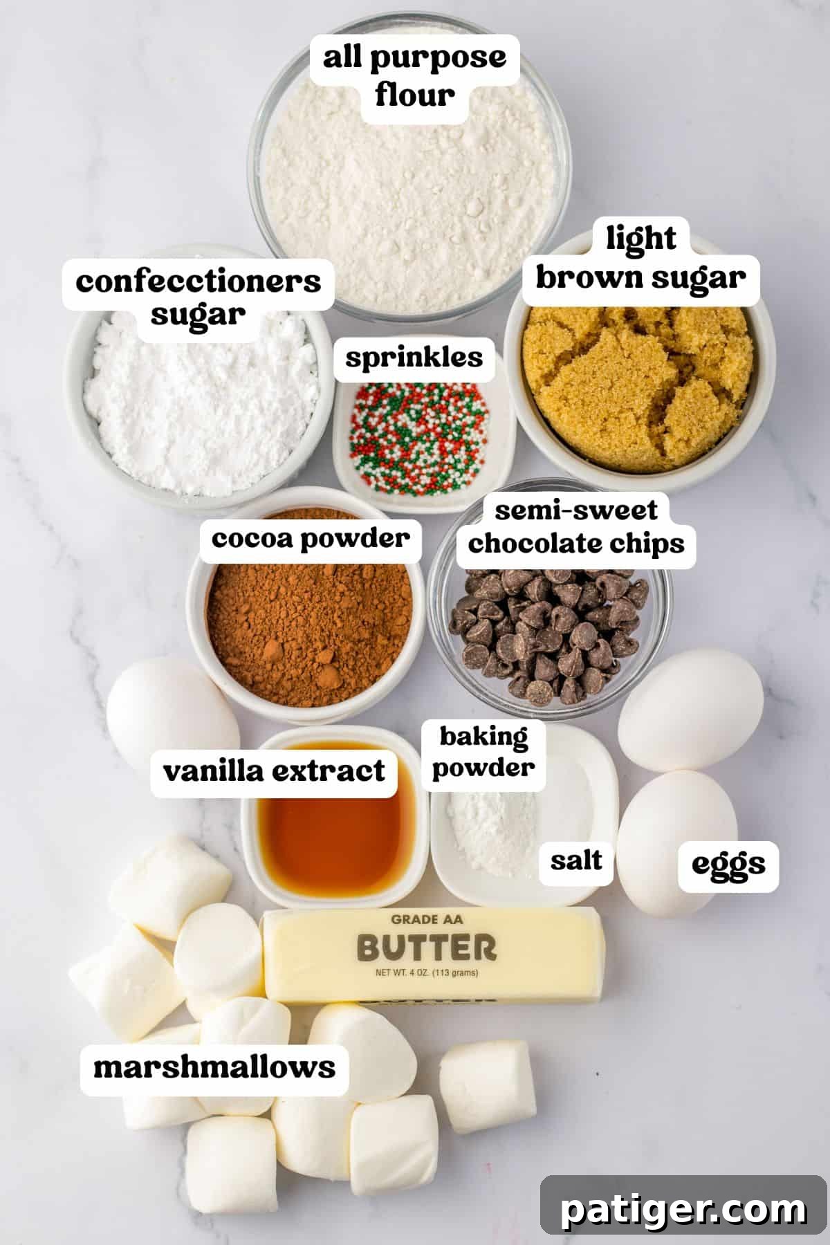 Cozy Hot Cocoa Cookies 3 Ingredients for hot chocolate cookies, including flour, brown sugar, cocoa powder, marshmallows, chocolate chips, and festive sprinkles.