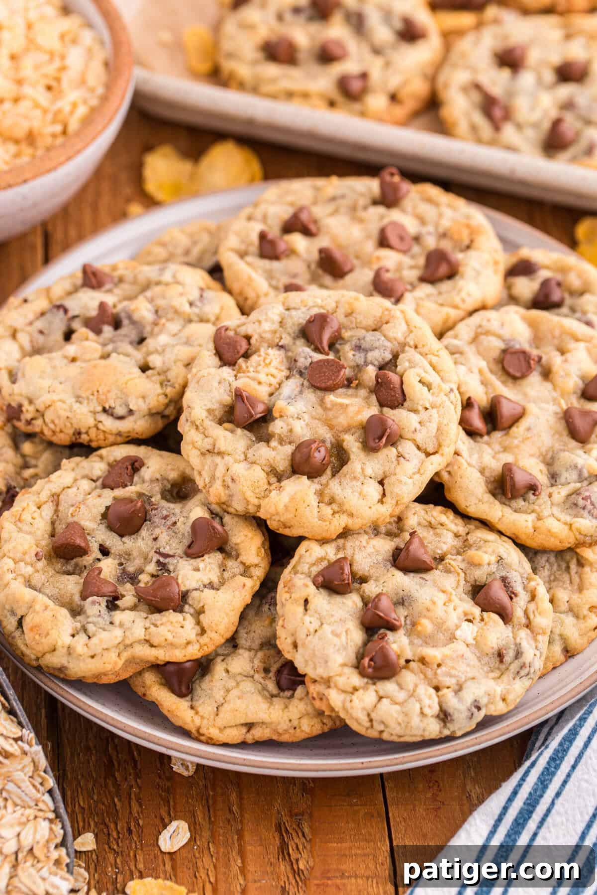 Plate filled with Ranger Cookies featuring chocolate chips and cornflakes, emphasizing their rustic and hearty appearance with a mix of textures. Perfect for a cozy treat or sharing.