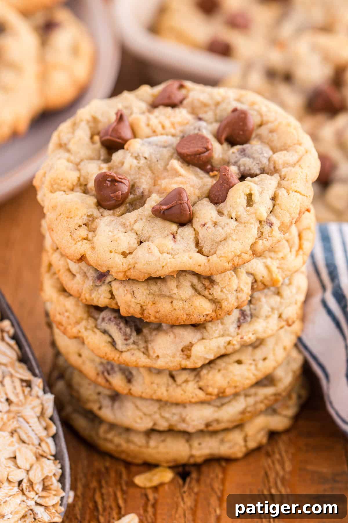 Close-up of a stack of golden-brown Ranger Cookies loaded with chocolate chips, oats, and crispy flakes, highlighting their soft and chewy texture with crunchy edges. Irresistible and inviting.