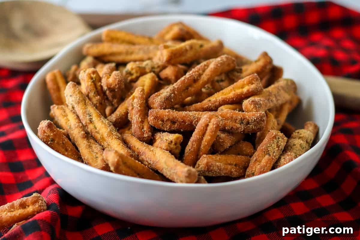 A pristine white bowl brimming with perfectly seasoned pretzel twists, their golden-brown texture and vibrant spice coating clearly visible, strikingly similar to the famous Dot's Pretzels.