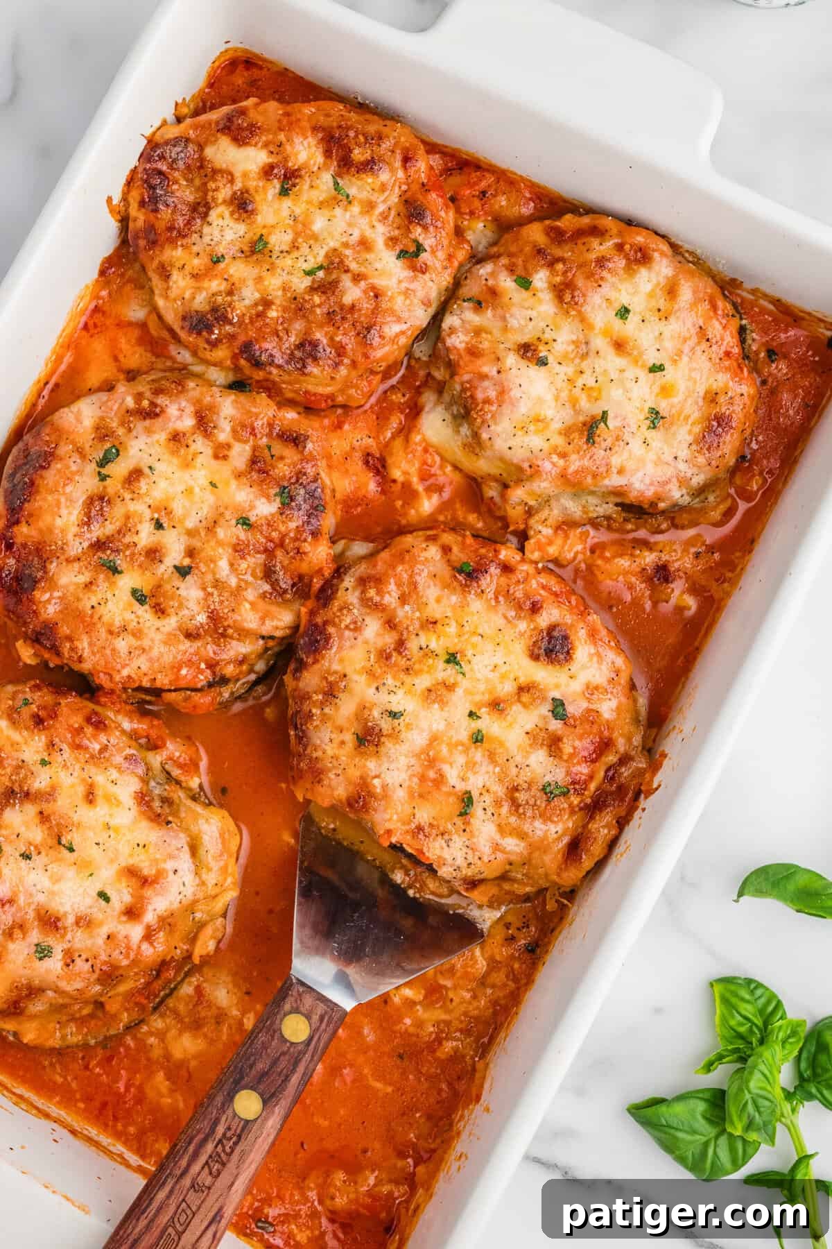 Golden-brown baked eggplant Parmesan in a 9 x 13 baking dish, ready to be served.
