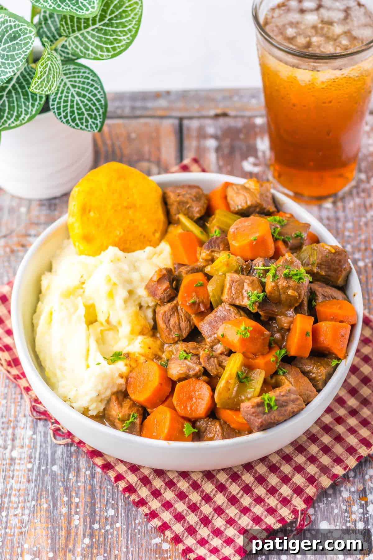 Bowl of slow cooker cracker barrel copycat pot roast with carrots, celery, mashed potatoes, and a biscuit. The beef is fall-apart tender, surrounded by rich gravy and wholesome vegetables.