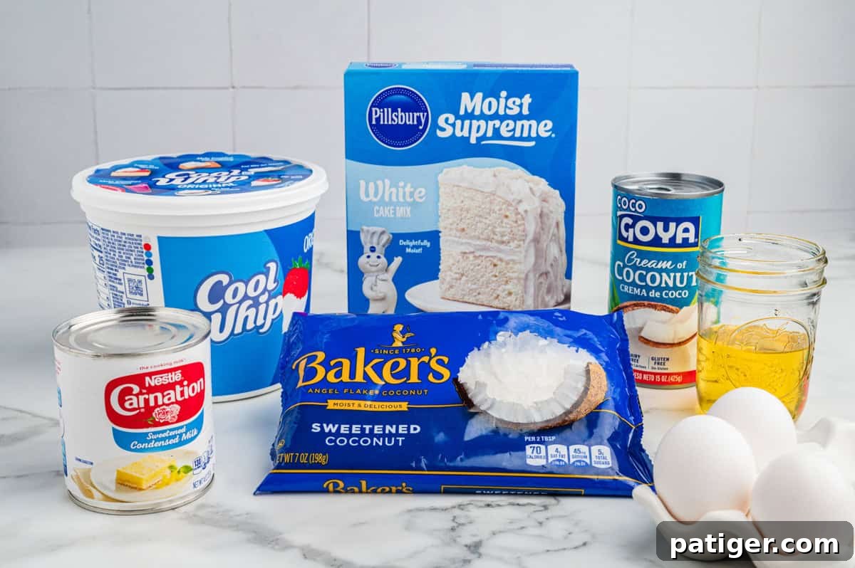 Tropical Coconut Poke Cake 3 Ingredients for a coconut poke cake, including a tub of Cool Whip, a box of Pillsbury Moist Supreme White Cake Mix, a can of Goya cream of coconut, a can of Carnation sweetened condensed milk, a bag of Baker's sweetened coconut flakes, three eggs, and oil.