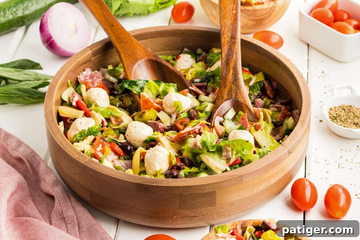 Chopped antipasti salad served in a wooden bowl.