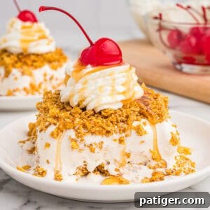 Fried ice cream cake on a white plate, coated in a crispy golden crust, topped with whipped cream, caramel drizzle, and a maraschino cherry.