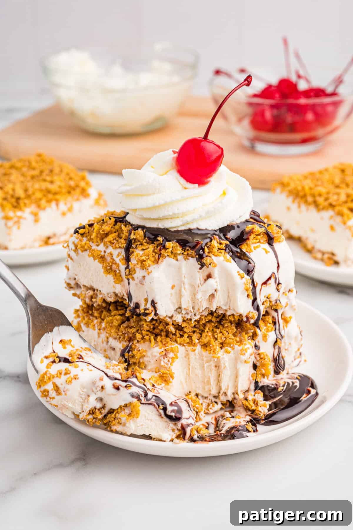 Golden Fried Ice Cream 3 Layered fried ice cream dessert with whipped cream, chocolate syrup, and a cherry.
