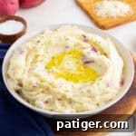 Rustic Red Potato Mash 8 Bowl of red skin mashed potatoes with butter and herbs.
