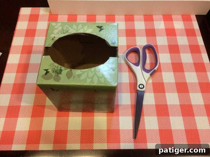 Tall tissue box with slit in top expanded to go from side to side for lottery ticket pull.