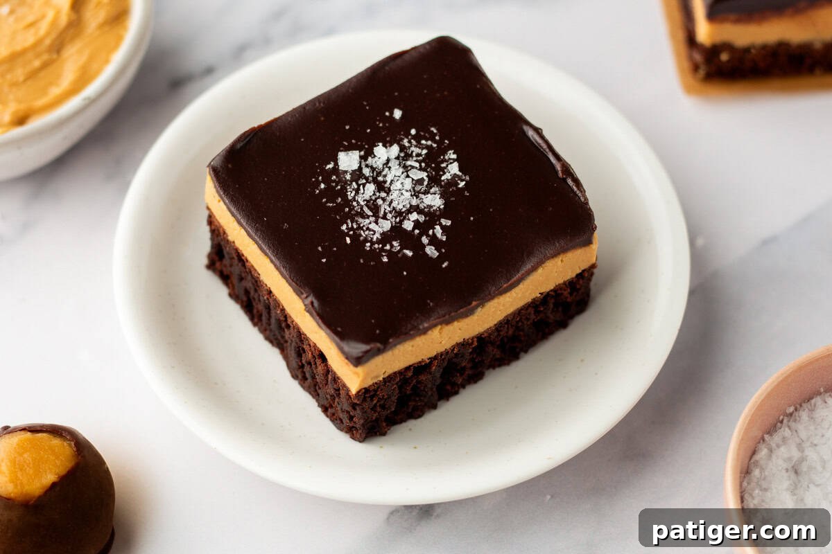 Decadent Buckeye Brownies 8 Chocolate peanut utter buckeye brownie on a white plate.