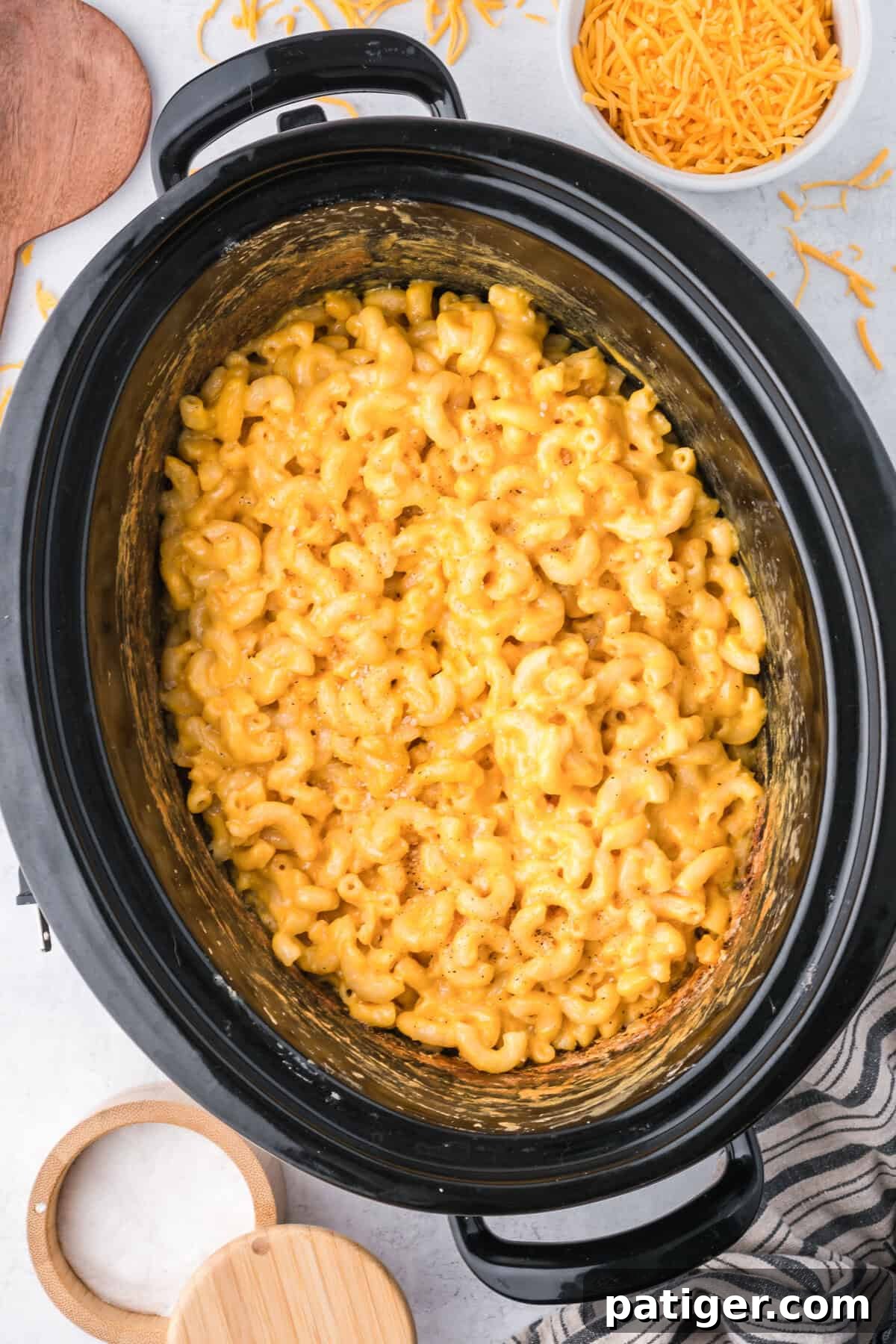 Overhead view of crockpot mac and cheese with velveeta, generously portioned in a serving dish, highlighting its creamy texture.