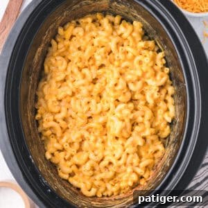 Creamy macaroni and cheese in a slow cooker, ready to be served.