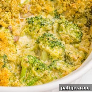Broccoli casserole topped with golden panko breadcrumbs in a white baking dish.