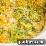 Broccoli casserole topped with golden panko breadcrumbs in a white baking dish.