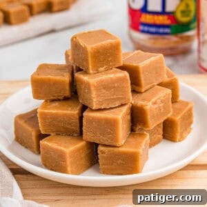 Stack of peanut butter fudge on a white plate.
