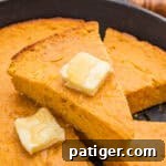 Slice of sweet potato cornbread with honey butter.