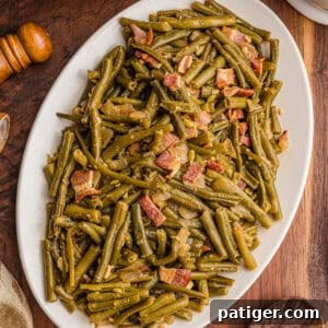 Southern green beans with bacon on a white serving platter.
