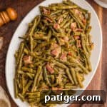 Southern green beans with bacon on a white serving platter.