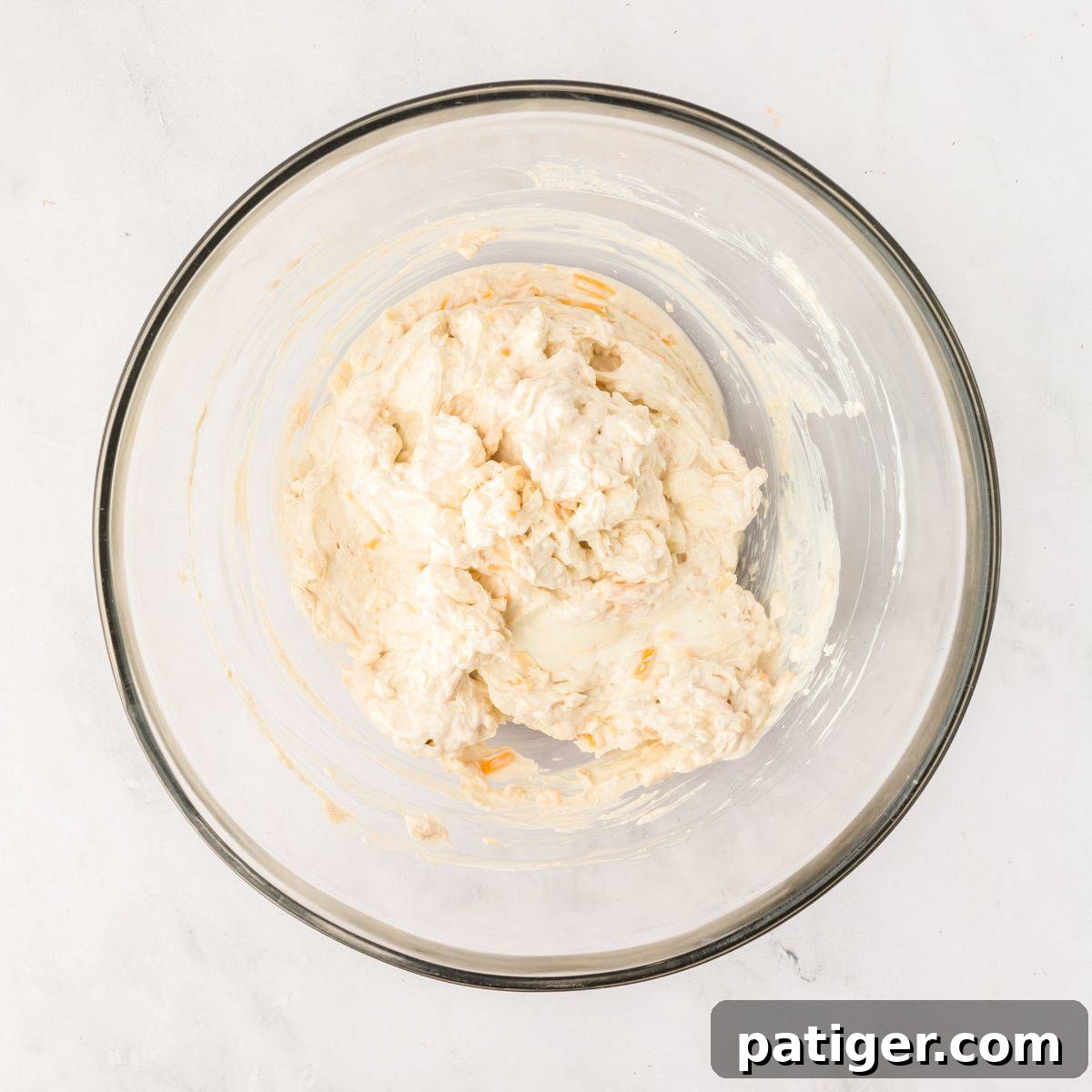 Cheese ball mixture in a glass bowl.