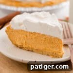 Slice of no-bake pumpkin pie on a plate with a fork.