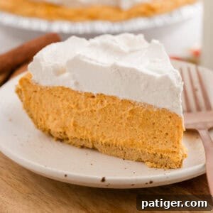 Slice of no-bake pumpkin pie on a plate with a fork.